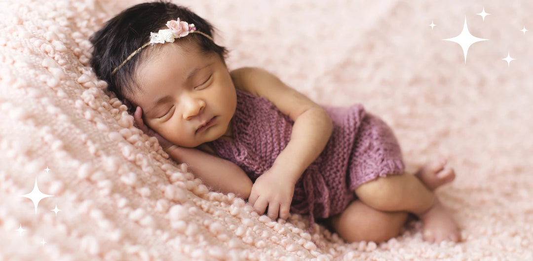 top 50 baby girls names 2023 blog image baby wrapped in purple with flower headband
