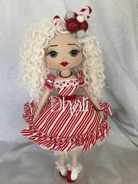 Candy cane inspired Christmas Ornament doll, wearing a white and red stripe dress, sequin and diamante detail, white blond curly hair and candy cane head piece