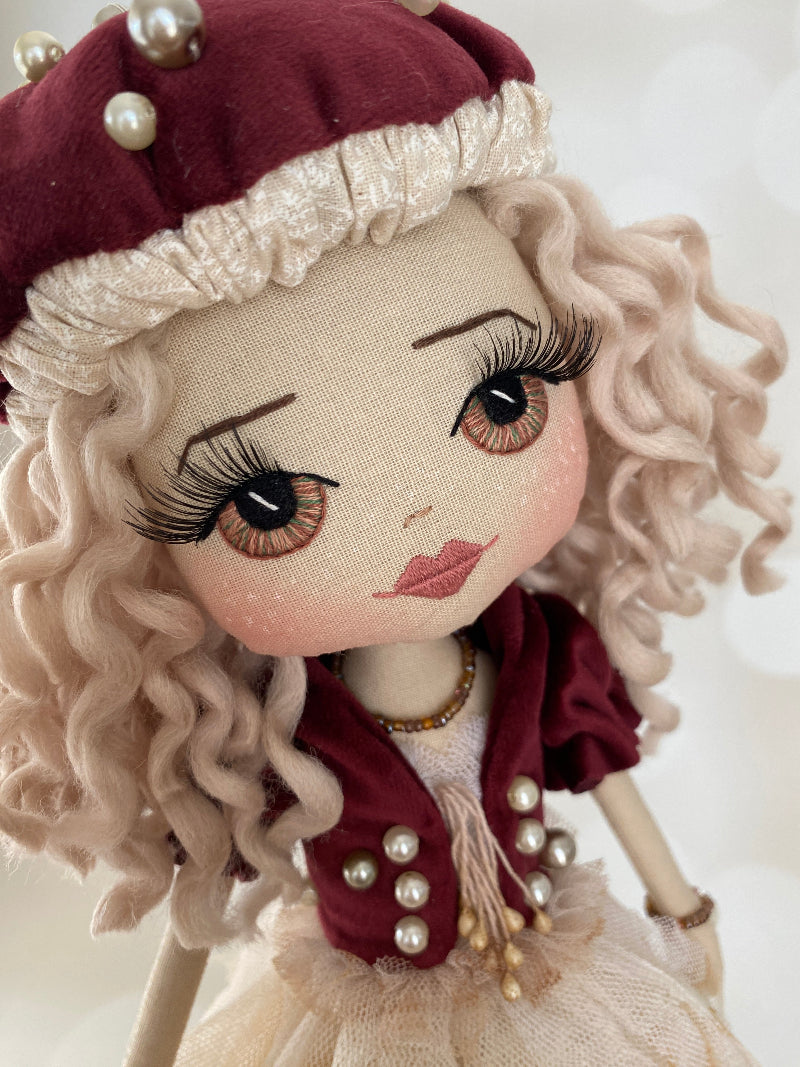 Mushroom Fairy Doll handmade by Upper Dhali featuring an up close view of the hand embroidered face featuring hazel eyes, long black lashes and white freckles