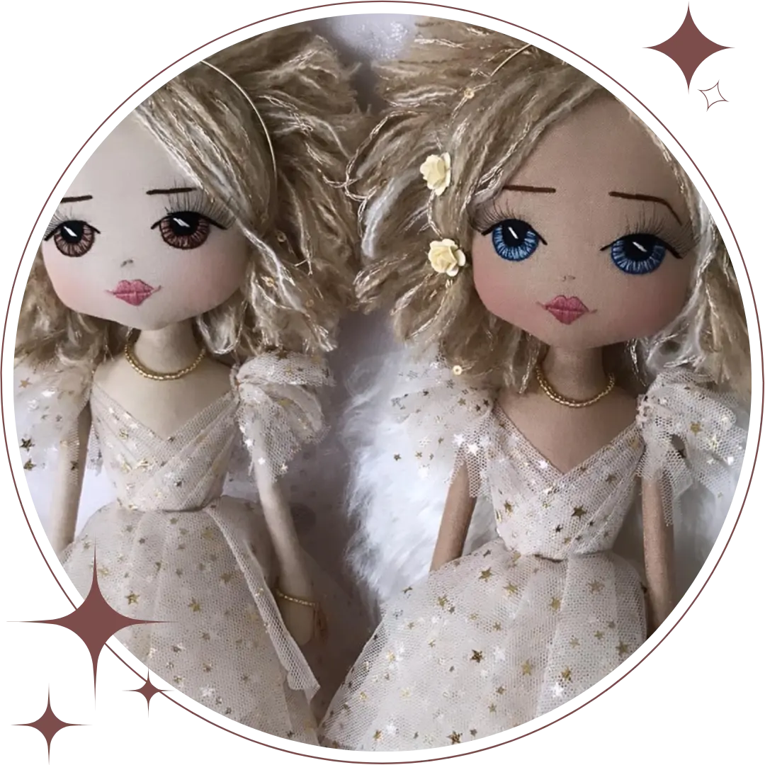 two blond handmade angel dolls one with blue eyes, the other with brown eyes, wearing a golden tulle dress with gold stars