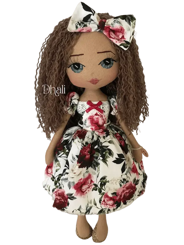 Personalised handmade doll wearing a Christmas floral dress and hair bow. Hand embroidered blue eyes with 3d lashes, gold glitter shoes and long wavy yarn hair