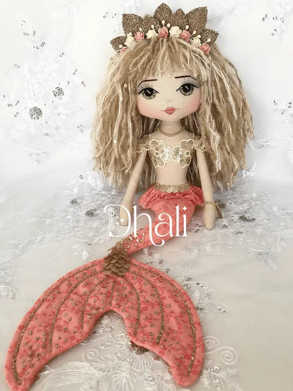 Beautiful handmade mermaid doll with coral orange tail and gold glitter and sequin detail, gold sequin mermaid bodice and mermaid crown. Two tone long blond hair, bangs and hand embroidered green eyes with eyelashes.