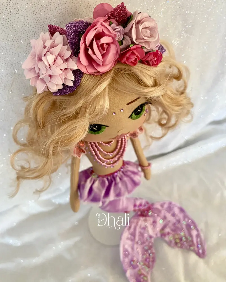 Handmade mermaid doll with purple tail and fuchsia pink sequin and bead detail. Featuring a flower mermaid crown with glitter leaves, hand embroidered face featuring green eyes