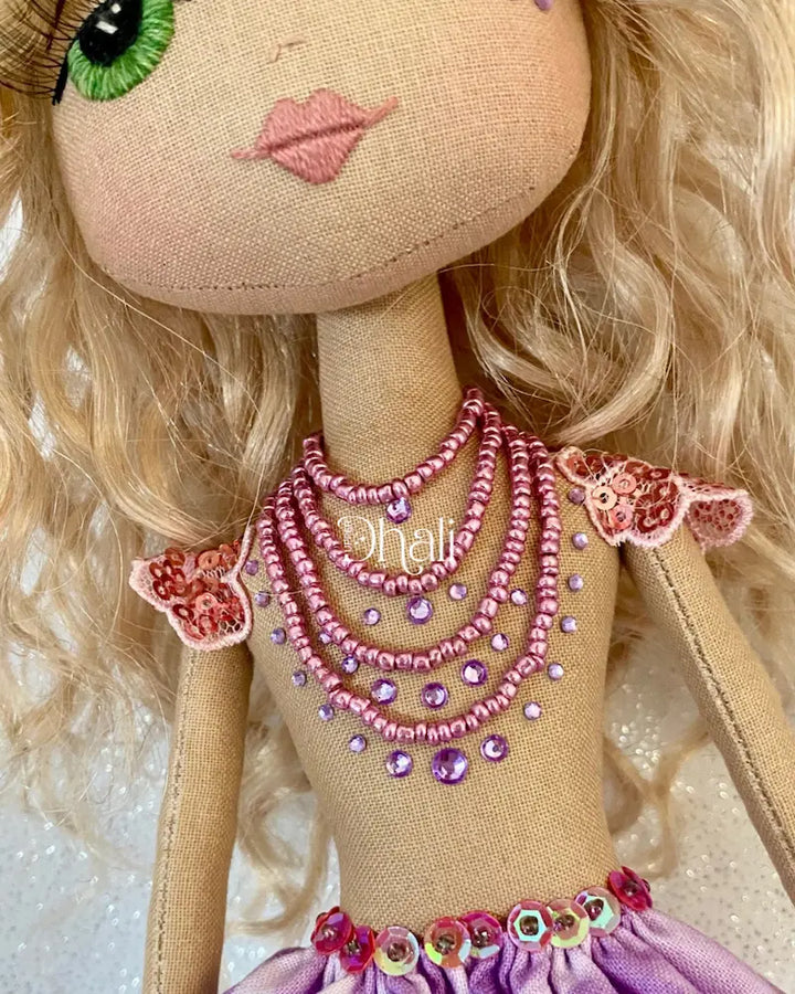 Handmade mermaid doll with purple tail and fuchsia pink sequin and bead detail. Featuring a flower mermaid crown with glitter leaves, hand embroidered face featuring green eyes