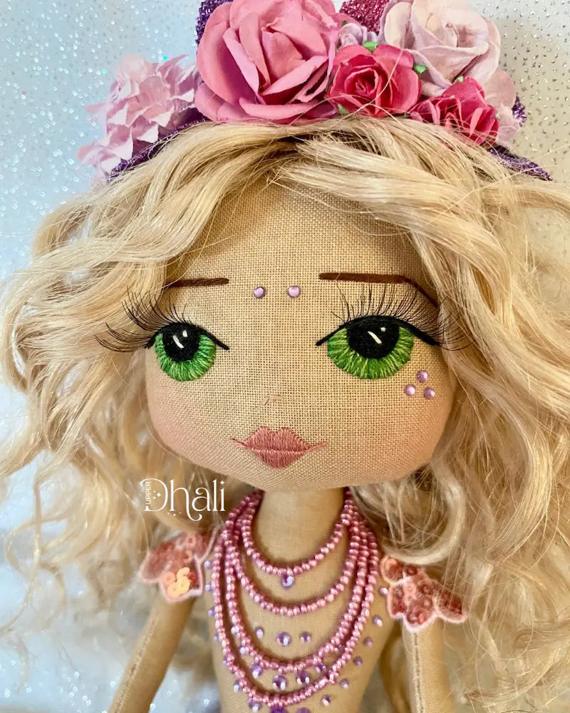 Handmade mermaid doll with purple tail and fuchsia pink sequin and bead detail. Featuring a flower mermaid crown with glitter leaves, hand embroidered face featuring green eyes