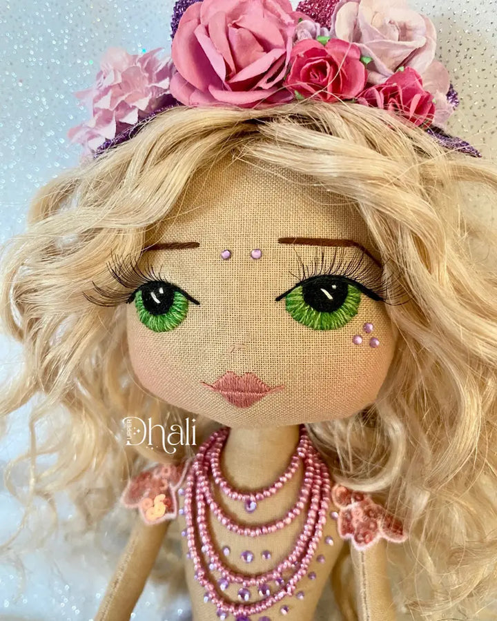 Handmade mermaid doll with purple tail and fuchsia pink sequin and bead detail. Featuring a flower mermaid crown with glitter leaves, hand embroidered face featuring green eyes