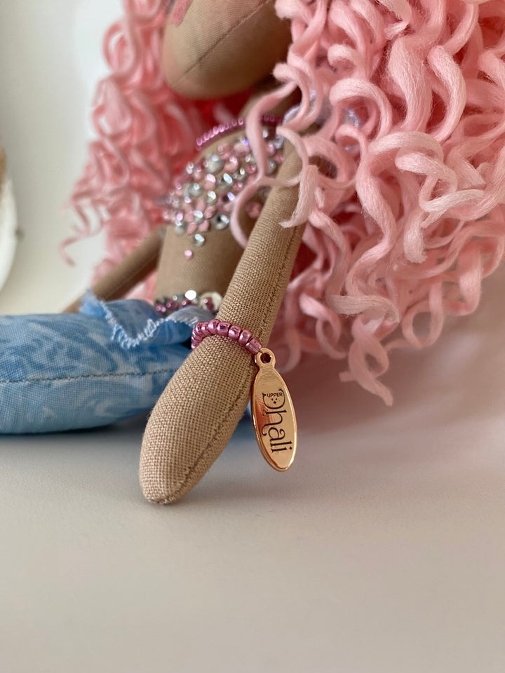 Mermaid Doll with blue tail, pink and silver diamante detail and mermaid bra. Curly hair made from hand rolled pink mohair fibre and a mermaid crown in silver with blue sequin detail. Doll features a hand embroidered face featuring blue eyes, pink lips and three dimensional eye lashes.