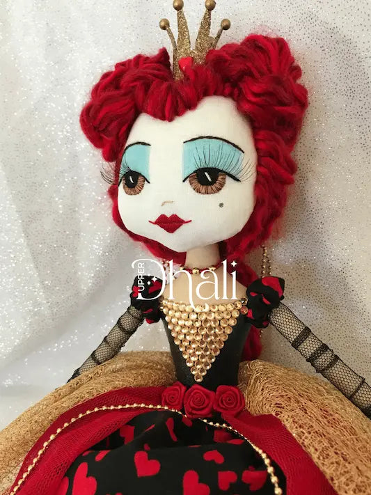 Queen of Hearts doll with glittered golden crown and red hair, wearing a gold, red & black hearts queen dress