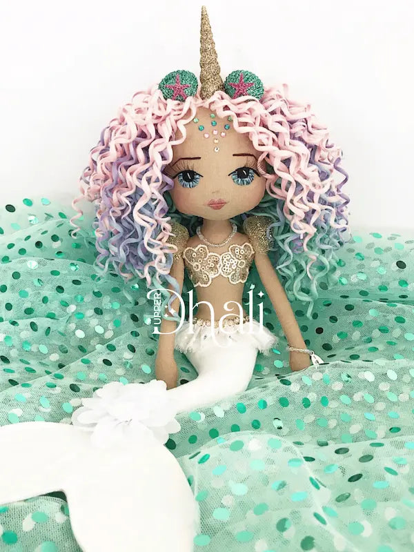 Rainbow Sparkles mermaid doll with white tail, gold sequin mermaid bodice, rainbow mermaid curly hair and glittered shell unicorn horn hair accessory