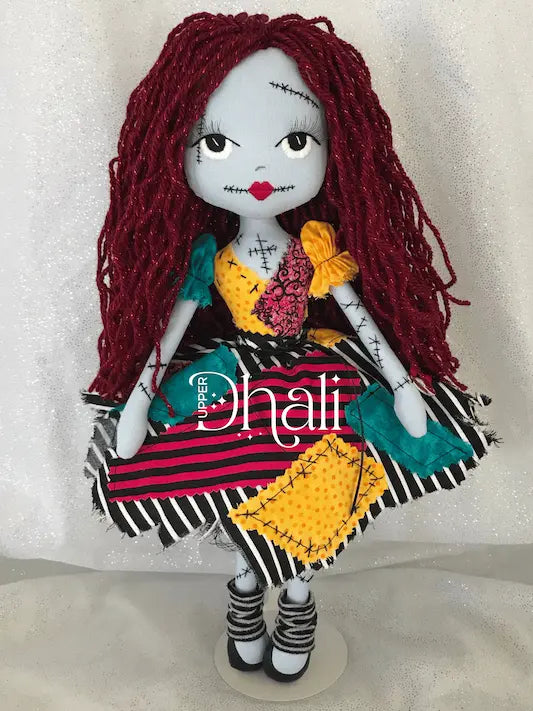 Sally Nightmare Christmas handmade doll featuring blue skin, red hair, scrappy fabric rag doll dress and hand embroidered face