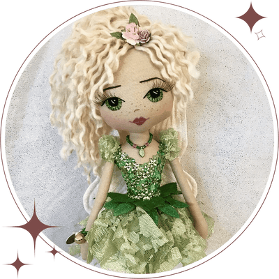 Upper Dhali handmade fairy doll wearing a gree fairy dress with sequin and diamante bodice, blonde hair in a high ponytail, hand embroidered face featuring gree eyes