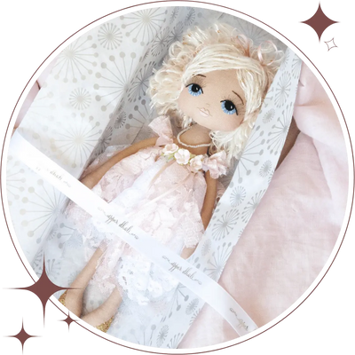 Upper Dhali handmade doll wearing a pink and white chantilly lace vintage inspired dress with flower detail featuring hand embroidered face with blue eyes and short blonde sequin yarn hair
