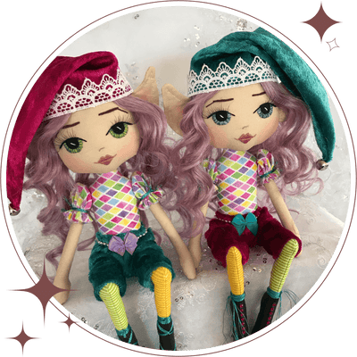 two handmade elf dolls wearing jewel colours of teal, fushia, emerald pants & hat with purple hair