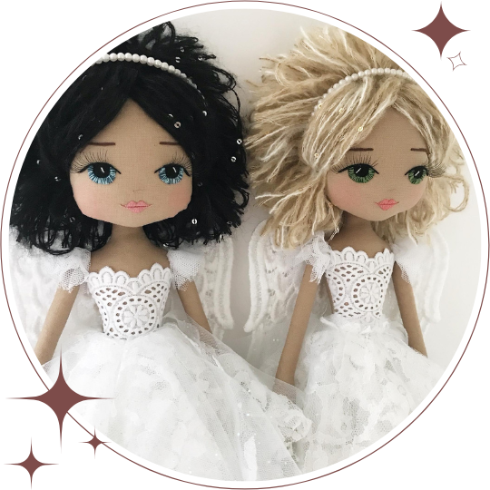 Two dolls in white wedding dresses with lace details on a white background.