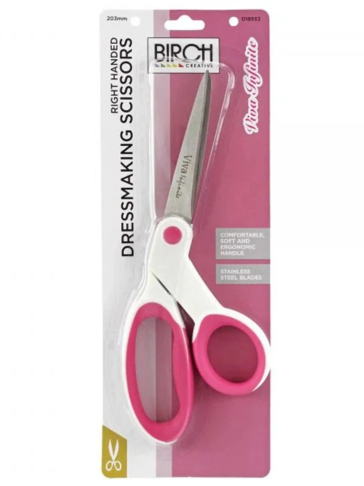 Packaged dressmaking scissors with pink handles on a white background