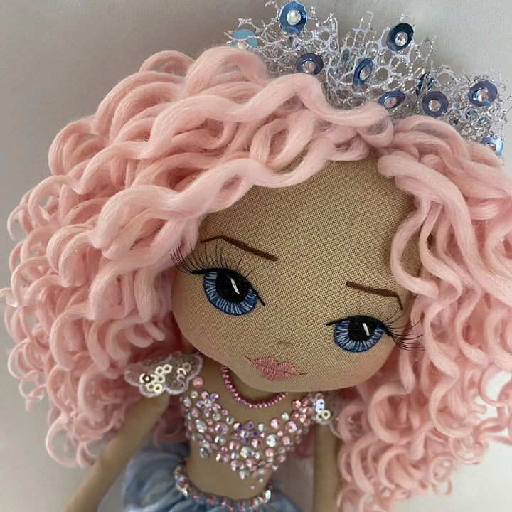 Close-up of Mirren’s silver and blue mermaid tiara nestled among her pastel curls.