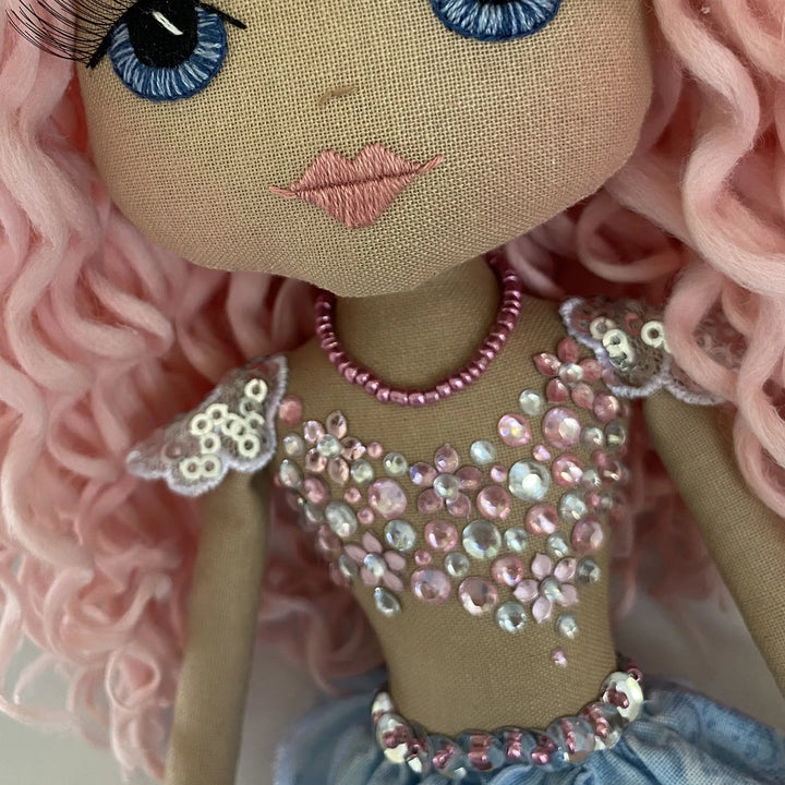 Close-up of Mirren the mermaid doll’s jeweled bodice, featuring soft pink and silver sequins with delicate detailing.