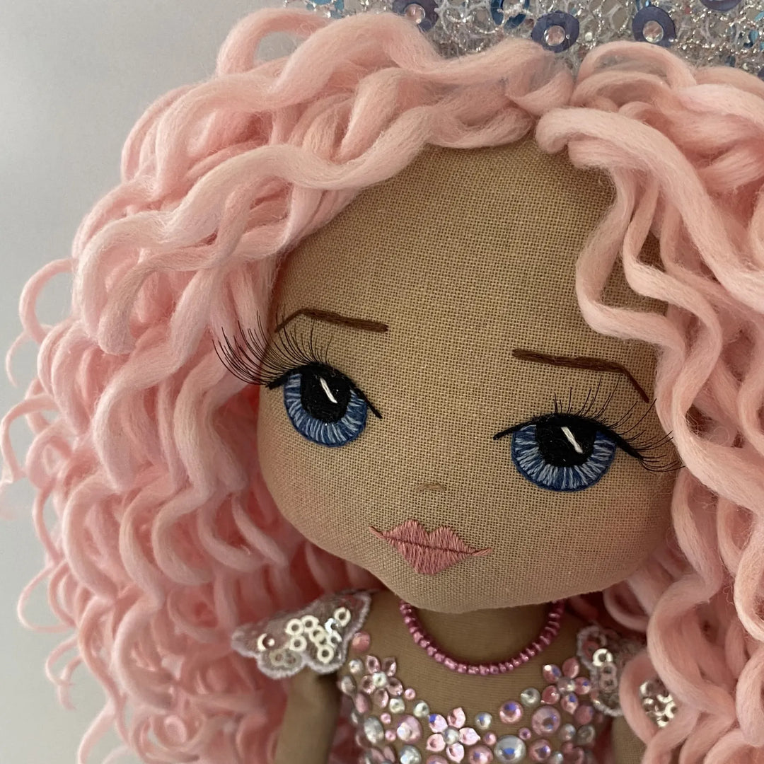 Mirren the mermaid doll’s hand-embroidered face with soft blue eyes, 3D lashes, and a serene expression.