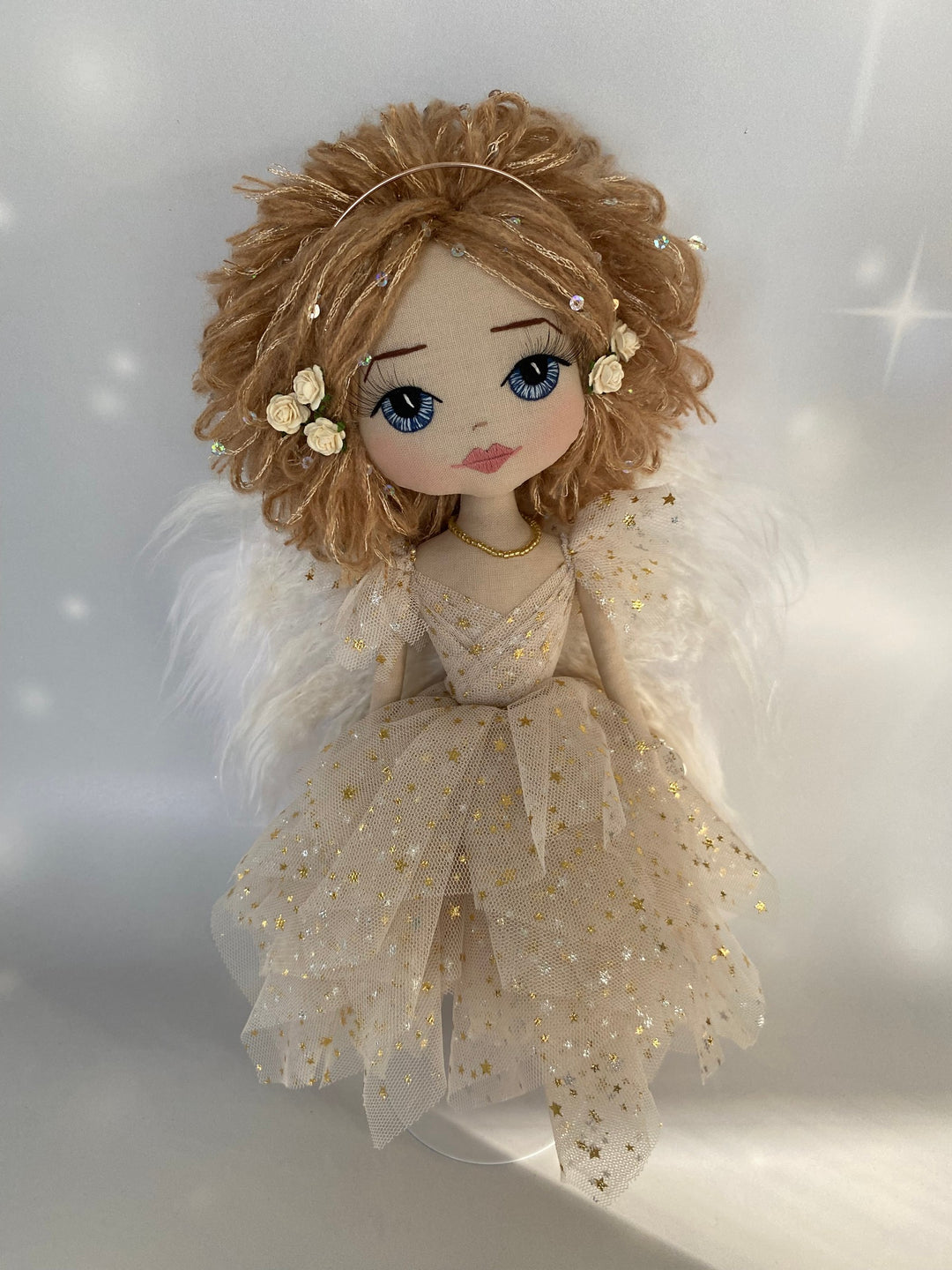 Christmas Angel handmade keepsake doll featuring a beige tulle dress with gold stars, strawberry blond sequin adorned hair, hand embroidered face with blue eys and eri silk angel wings