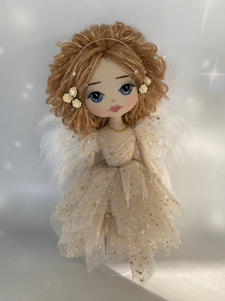 Christmas Angel handmade keepsake doll featuring a beige tulle dress with gold stars, strawberry blond sequin adorned hair, hand embroidered face with blue eys and eri silk angel wings