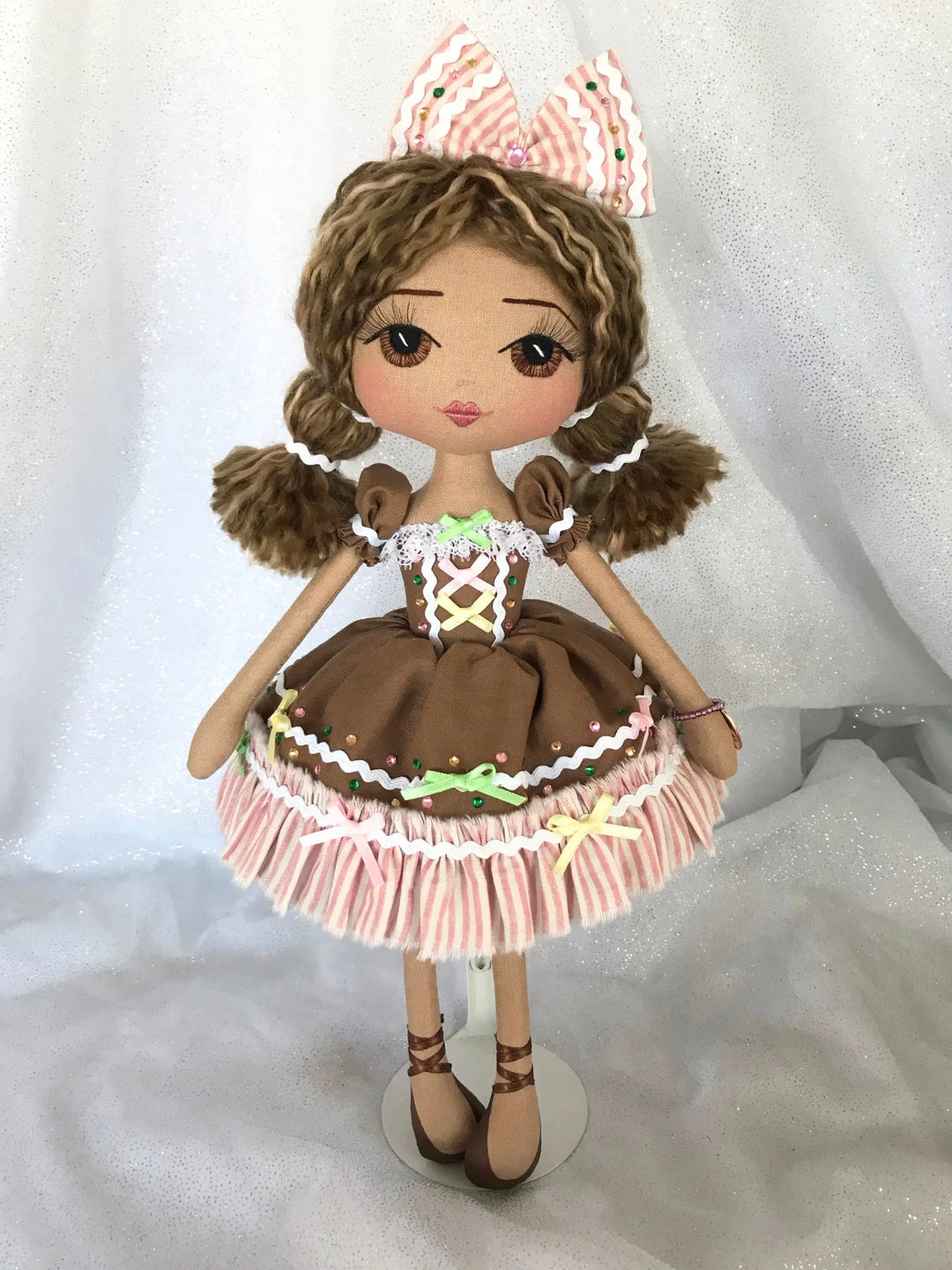 Handmade doll wearing a gingerbread house inspired dress made by Upper Dhali