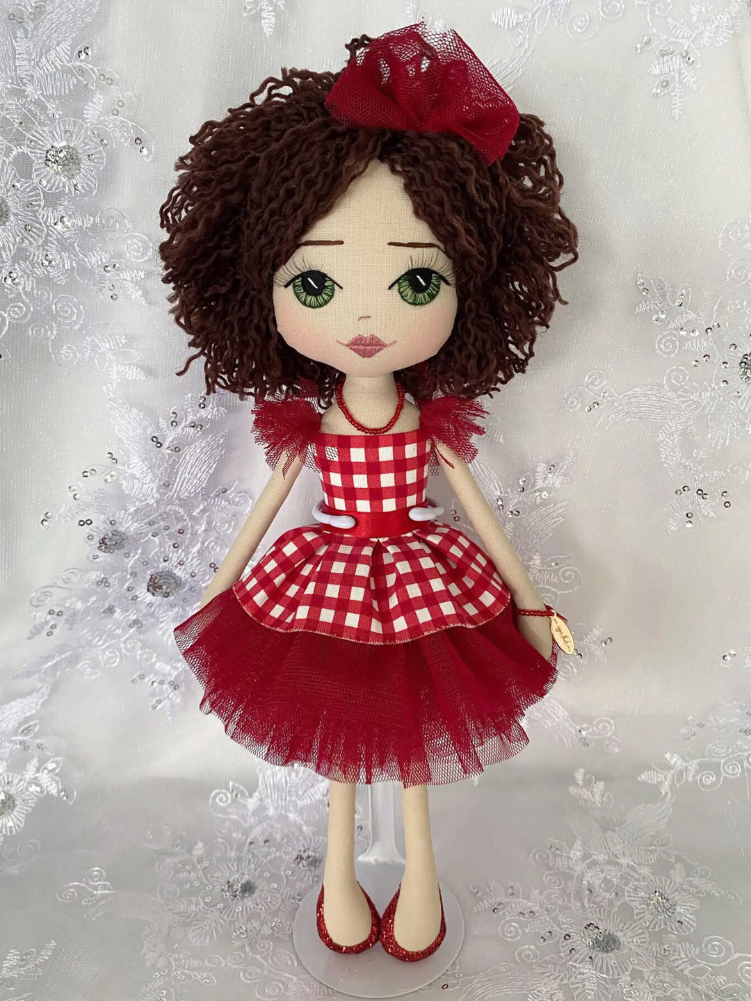 Doll with red ginham dress and matching bow made by Upper Dhali