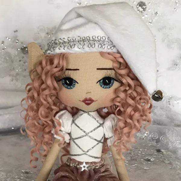 Decorative doll with white outfit and tiara against a glittery background