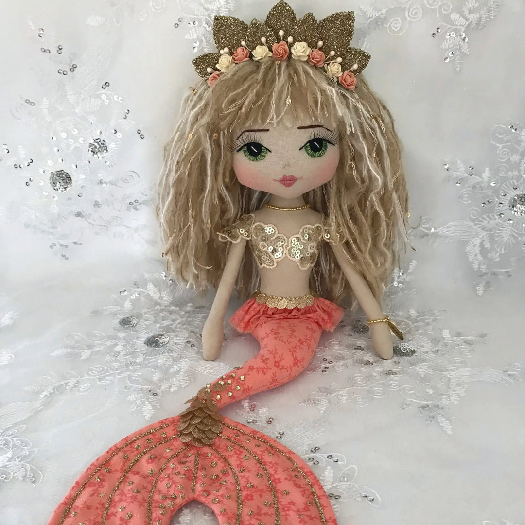 Mermaid doll with a gold crown and orange tail by Upper Dhali