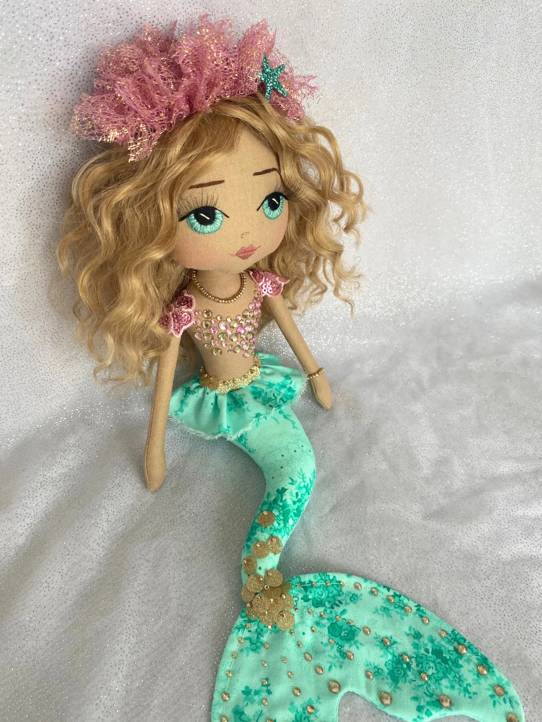Selkie Jade Mermaid doll with a jade green tail, pink bodice, gold detail. Made by Upper Dhali.