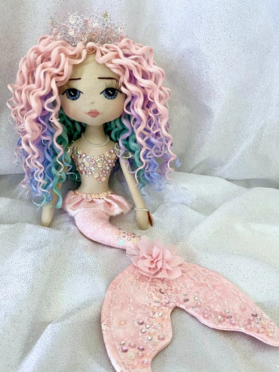 Handmade mermaid doll featuring a pink tail with silver & pink sequin and diamante detail, hand embroidered face with blue eyes and pastel rainbow curly hair with silver coral inspired mermaid crown