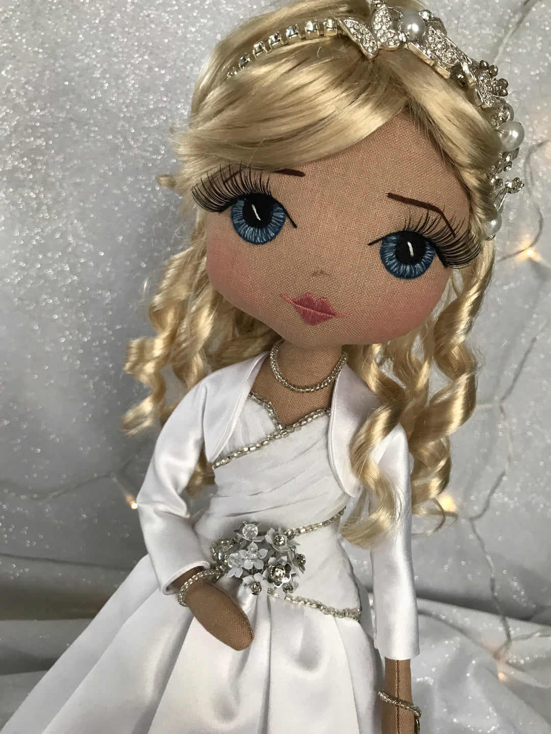 Custom made wedding dress keepsake doll with hand embroidered face featuring blue eyes, blonde hair and a silver butterfly headpiece