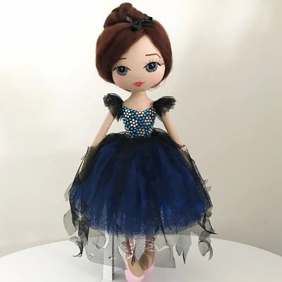 handmade ballerina keepsake doll wearing a blue and black tutu, pink ballet slippers, with dark brown hair in a bun and hand embroidered blue eyes