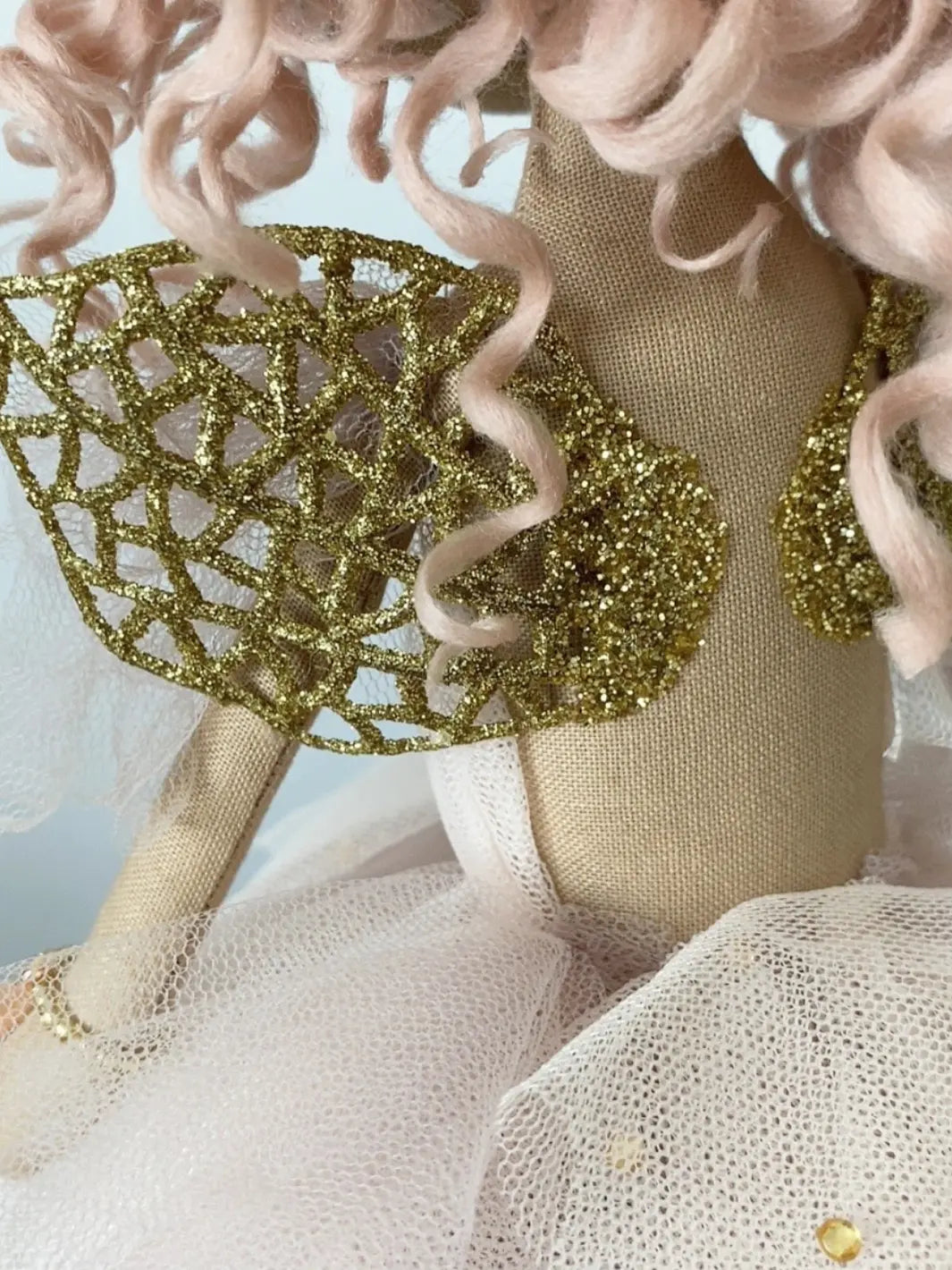 Pink handmade fairy doll with embroidered face. Featuring gold fairy wings, green eyes, pink hand rolled curly hair