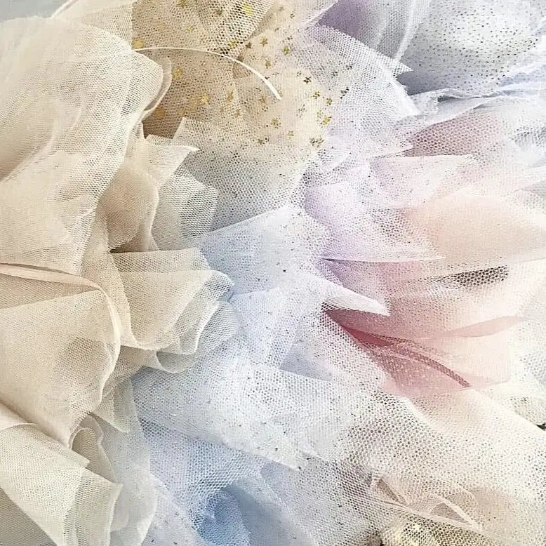 assorted colours of tulle tutus in white, pink, blue, lavender and gold star sparkle