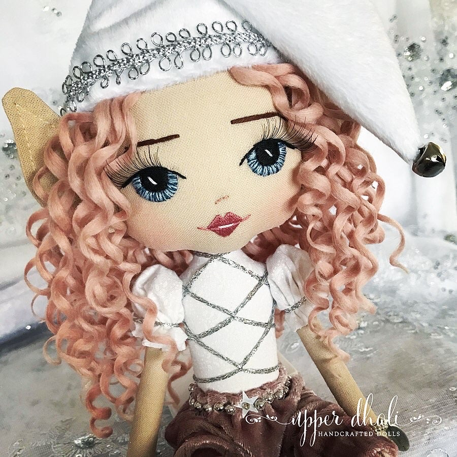 dusy pink and white christmas elf with pink curly hair