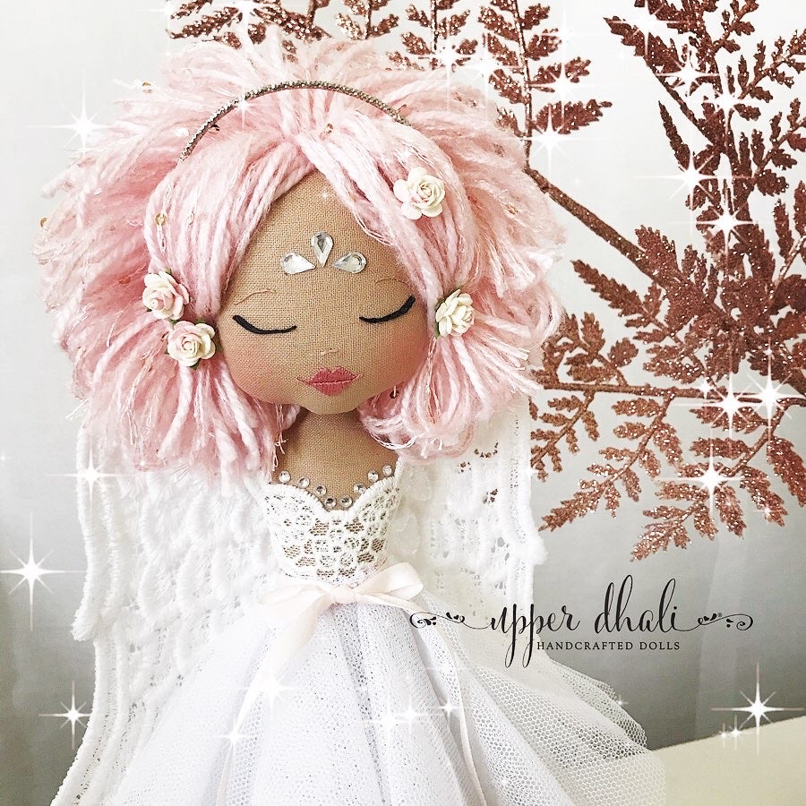 angel tree topper with a white dress, pink hair and closed eyes