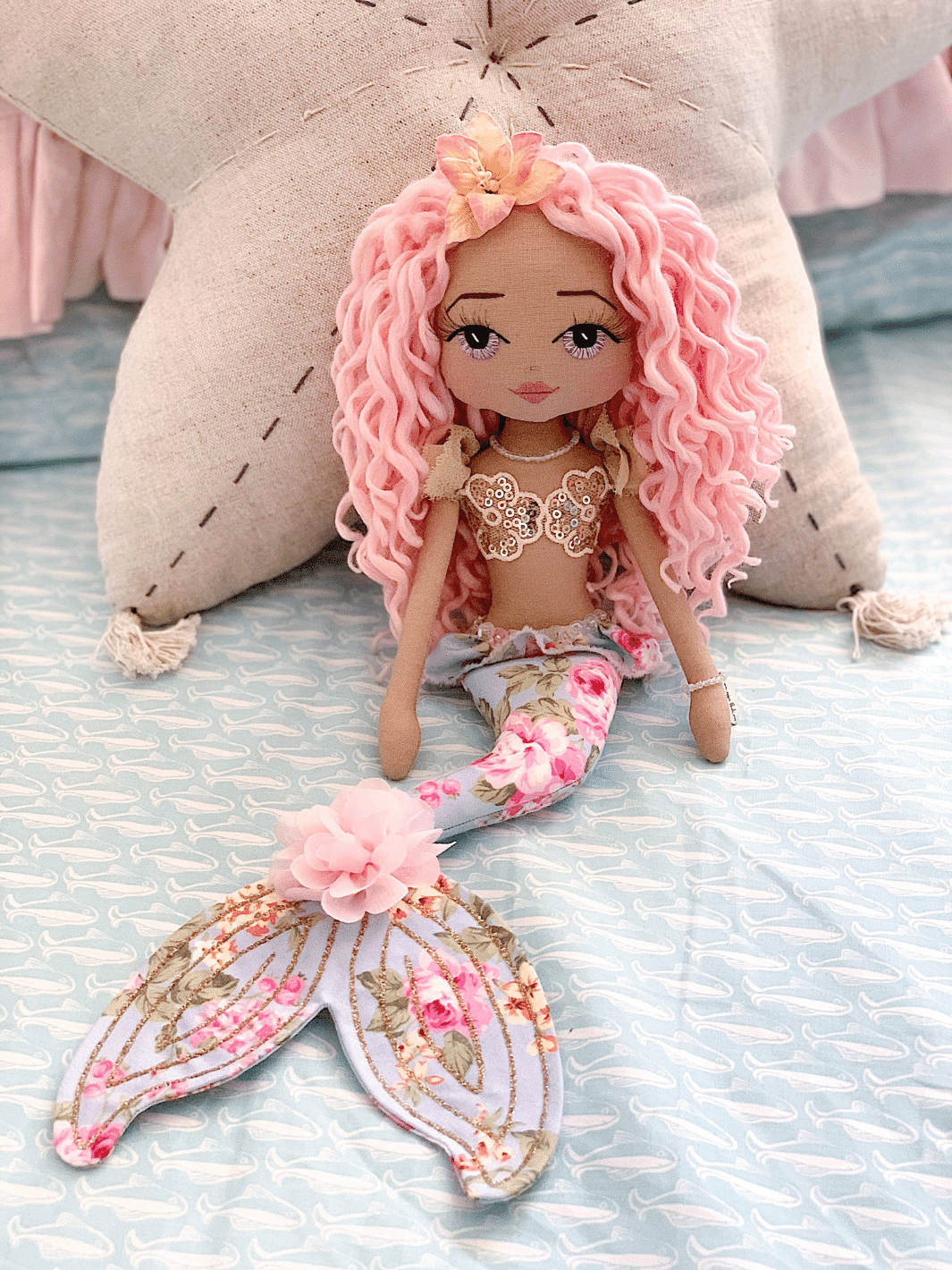 Best selling Anahita handmade mermaid doll with long pink curly hair, lavender hand embroidered eyes, gold mermaid bodice and blue floral mermaid tail with gold glitter detail